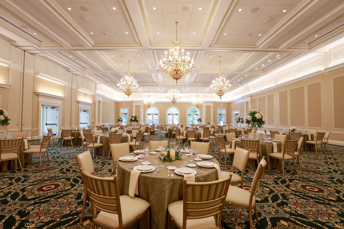 The Hunter Hall ballroom set with round tables with white tablecloths and dinner place settings